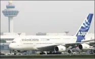  ?? Roslan Rahman / Getty Images ?? The Airbus A380, the largest passenger jet, completes its first test flight outside Europe after landing at the Changi Internatio­nal Airport terminal in Singapore in November 2005.