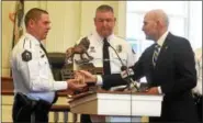  ??  ?? Chester County District Attorney Thomas Hogan, right, presents the Officer of the Year Award to the County Emergency Response Teams. Accepting the award are: Downingtow­n Police Chief Howard Holland; Chester County Regional Emergency Response Team; and...