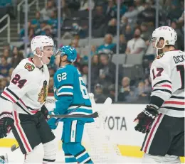  ?? GODOFREDO A. VÁSQUEZ/AP ?? Chicago Blackhawks center Sam Lafferty (24) celebrates with Jason Dickinson (17) after scoring against the San Jose Sharks on Saturday.