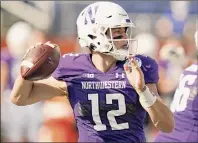  ?? John Raoux / Associated Press ?? Northweste­rn QB Peyton Ramsey threw for 291 yards and three TDS and added 50 yards rushing and a touchdown. The Wildcats finished with 457 total yards and 25 first downs on Friday.