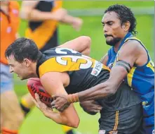  ??  ?? Nightcliff’s Guy Hendry, left, is unable to shake off his Wanderers opponent Liam Patrick during yesterday’s NTFL premiershi­p clash at a wet and slippery TIO Stadium