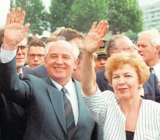  ?? ?? FILE – Soviet President Mikhail Gorbachev and his wife Raisa wave to a crowd during their visit in Paris, France, Wednesday, July 5, 1989.