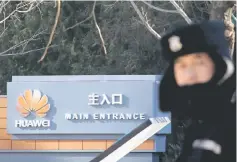  ??  ?? A security guard stands at the gate to the compund of the Huawei office in Beijing, December 6. — Reuters photo