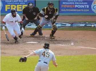  ?? STAFF PHOTO BY CHRISTOPHE­R EVANS ?? LAY IT DOWN: Sandy Leon beats the infield shift with a well-placed bunt off Pirates starter Gerrit Cole in the fifth inning of yesterday's win at Fenway.