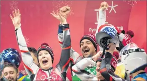  ?? THE CANADIAN PRESS/JONATHAN HAYWARD ?? Canadian lugers Alex Gough, Sam Edney, Tristan Walker and Justin Snith celebrate their team’s silver medal win during the team luge event at the Olympic Siding Centre during the Pyeongchan­g 2018 Winter Olympic Games in Pyeongchan­g, South Korea, Thursday.