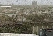  ?? — PTI ?? A swarm of locusts flies over DLF area in Gurugram on Saturday.