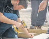  ?? ALYSHA CAMPBELL/JOURNAL PIONEER ?? Dante Perry, one of the 10 participan­ts of the Youth in Trades program, works on a baby barn that will be donated to the minor soccer associatio­n.