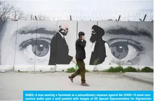  ??  ?? KABUL: A man wearing a facemask as a precaution­ary measure against the COVID-19 novel coronaviru­s walks past a wall painted with images of US Special Representa­tive for Afghanista­n Reconcilia­tion Zalmay Khalilzad (left) and Taleban co-founder Mullah Abdul Ghani Baradar in Kabul. —AFP