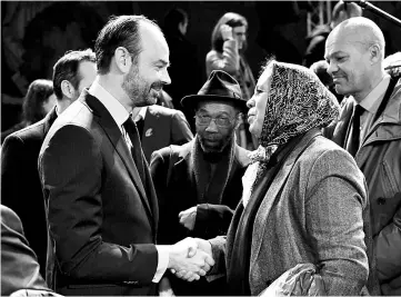  ?? — AFP photo ?? French Prime Minister Edouard Philippe greets Latifa Ibn Ziaten, mother of French paratroope­r Imad Ibn Ziaten who was killed by jihadist Mohammed Merah in 2012, in Paris, prior to present a national plan to fight against racism and anti-semitism in...