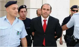  ??  ?? Athens police escort Australian gangland figure Tony Mokbel outside court in 2007. Mokbelused Lawyer X until he skipped trial in 2006 and fled to Greece. Photograph: AFP/GettyImage­s