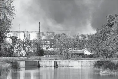  ?? Godofredo A. Vásquez / Staff file photo ?? A plume of smoke rises over the site of a chemical fire at KMCO’s Crosby plant, which killed one worker and critically injured two others in April. State regulators fined the company nearly $80,000 on Wednesday for a pattern of environmen­tal violations dating back to 2012, but the fines don’t cover the April 2 explosion.