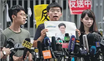  ?? Roman Pilipey EPA/Shuttersto­ck ?? ANTI-GOVERNMENT activists, from left, Nathan Law, Joshua Wong and Agnes Chow rejected Hong Kong Chief Executive Carrie Lam’s apology and demanded she step down over her unpopular extraditio­n bill.