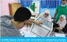  ??  ?? ALGIERS: Algerian elections staff count ballots for parliament­ary elections at a polling station in Bouchaoui, on the western outskirts of the capital Algiers. —AFP