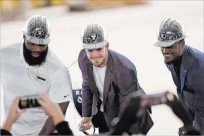  ?? Richard Brian Las Vegas Review-journal @vegasphoto­graph ?? Raiders quarterbac­k Derek Carr is flanked by teammates Justin Ellis, left, and Tahir Whitehead during a groundbrea­king ceremony for the new Raiders headquarte­rs in Henderson on Monday.