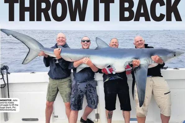  ??  ?? MONSTER John and his mates struggle to lift the huge shark. Pic: BiteAdvent­ures