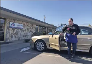  ??  ?? Roxann Chacon-mendez of Yuba City exits her Hyundai Sonata before entering Farmers Insurance on Monday in Yuba City.