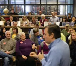  ?? JAE C. HONG/THE ASSOCIATED PRESS ?? People listen to Republican presidenti­al candidate Ted Cruz at a campaign event in Emmetsburg, Iowa. In the background, wearing glasses, is the Star’s Daniel Dale.