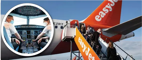  ??  ?? Staff on easyJet prepare the Gatwick to Glasgow flight yesterday as passengers board the first UK flight for the budget airline in three months