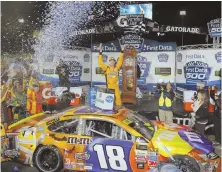  ?? AP PHOTO ?? TIME TO PARTY: Kyle Busch celebrates under the lights after winning in Martinsvil­le, Va., yesterday.