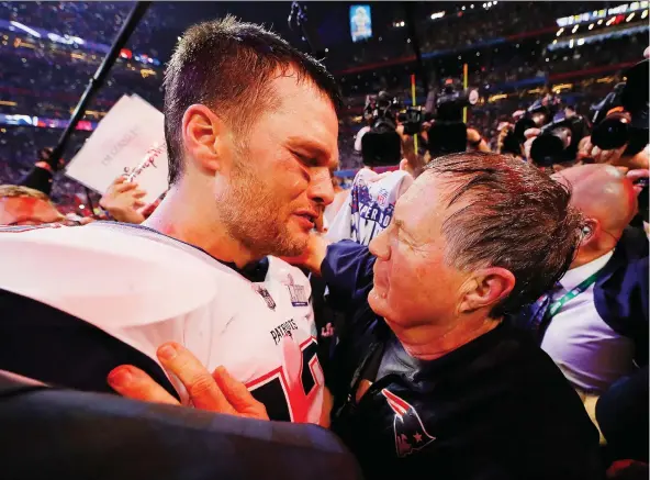  ?? KEVIN C. COX/ GETTY IMAGES ?? QB Tom Brady talks to head coach Bill Belichick after the Patriots defeated the Rams 13-3 in Super Bowl LIII to take their sixth title in 18 seasons dating back to 2001.