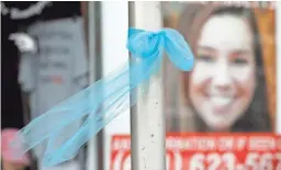 ??  ?? A ribbon for then-missing University of Iowa student Mollie Tibbetts hangs on a light post Tuesday in Brooklyn, Iowa.