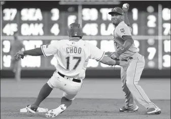  ?? AP/TONY GUTIERREZ ?? Texas’ Shin-Soo Choo (17) slides into second after being forced out by Royals' Alcides Escobar on Saturday in Arlington, Texas.