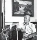 ?? PROVIDED TO CHINA DAILY ?? Hu Yichuan works on a painting at home in Guangzhou in 1986.