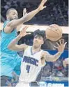  ?? PHELAN M. EBENHACK/AP ?? Hornets guard Kemba Walker, left, who scored 22, forces Elfrid Payton to turn the ball over.