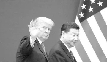  ??  ?? This file picture taken on November 9, 2017 shows US President Donald Trump (left) and China’s President Xi Jinping leaving a business leaders event at the Great Hall of the People in Beijing.The United States and China appear close to a deal that would roll back US tariffs on at least US$200 billion worth of Chinese goods, as Beijing makes pledges on structural economic changes and eliminates retaliator­y tariffs on US goods, a source briefed on negotiatio­ns said. — AFP photo
