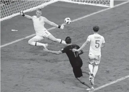  ?? Thanassis Stavrakis, The Associated Press ?? Croatia’s Mario Mandzukic, center, scores during extra time of the World Cup semifinal match against England on Wednesday at Luzhniki Stadium in Moscow. Croatia will play France for the title Sunday.