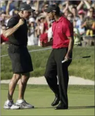  ?? CHRIS O’MEARA — THE ASSOCIATED PRESS FILE ?? In this file photo, Tiger Woods celebrates with his caddie, Steve Williams, after sinking a birdie putt on the 18th green, forcing a playoff against Rocco Mediate, during the fourth round of the U.S. Open golf tournament at Torrey Pines in San Diego....