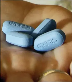  ?? JEFF CHIU — THE ASSOCIATED PRESS ?? In this file photo, a doctor holds Truvada pills at her office in San Francisco. The pill has been shown to reduce the risk of getting HIV from sex by more than 90 percent if taken daily.