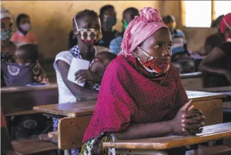  ?? World Food Program ?? People wait to collect food vouchers in Cabo Delgado province, Mozambique, after insurgents aligned with the Islamic State displaced 310,000 and caused an urgent humanitari­an crisis.