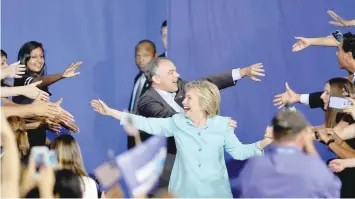  ?? – AFP ?? US Democratic Presidenti­al candidate Hillary Clinton and running mate US Senator Tim Kaine arrive for a campaign rally at Florida Internatio­nal University in Miami.