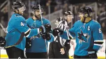  ?? TONY AVELAR — THE ASSOCIATED PRESS ?? The Sharks’ Brenden Dillon (4) is congratula­ted by Joe Pavelski (8) after scoring a goal against the Golden Knights on Thursday.