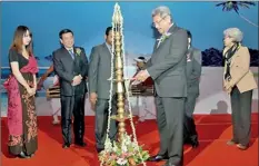  ??  ?? Secretary,ministry of Defence and Urban Developmen­t of Sri Lanka lighting the oil lamp at the ceremony