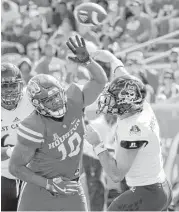  ?? Michael Wyke ?? Ed Oliver, left, has played effectivel­y in recent weeks despite wearing a brace after suffering a strained MCL on Sept. 30 during the game against Temple.