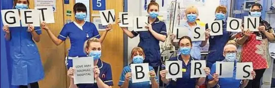  ??  ?? Sign language: Acute care unit staff show their support at Solihull Hospital in the West Midlands yesterday