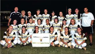  ?? Photos by TIM GODBEE / For the Calhoun Times ?? ( The Calhoun Lady Jackets pose for a team picture following their sweep of Ringgold to win their fifth straight region title. ( Calhoun’s Maddie Bumgardner (24) slides into home plate for a run during Game 1 on Wednesday.