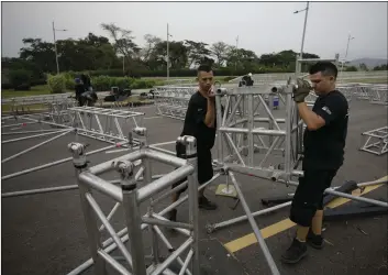  ??  ?? Workers build the stage for an upcoming concert coined: “Concert for the freedom of Venezuela” on the Colombian side of the Tienditas Internatio­nal Bridge on the outskirts of Cucuta, Colombia, on the border with Venezuela, on Monday. AP PHOTO/FERNANDO VERGARA