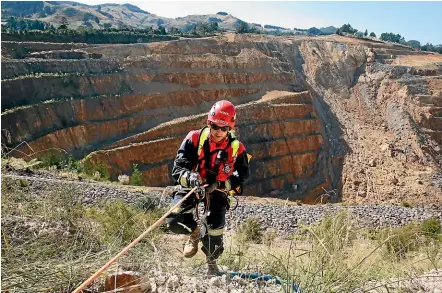  ?? MARK TAYLOR/STUFF ?? The only way down Waih¯ı’s open pit mine is by abseiling because the haul road is blocked.