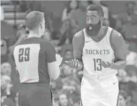 ?? Tim Warner / Getty Images ?? Rockets star James Harden is using the preseason to see how officials such as Mark Lindsay, left, handle the NBA’s clarificat­ion on calling shooting fouls.