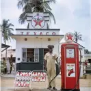  ?? Photograph: © 2021 Todd Webb Archive ?? A Texaco attendant in Togoland in 1958.