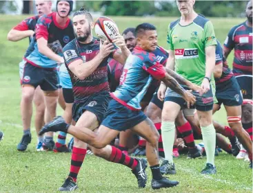  ??  ?? CONTROL: The Mariners' Robbie Rodokal evades Townsville Army's Christian Hughes.Picture: