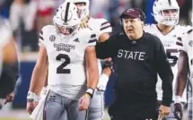  ?? AP PHOTO/ROGELIO V. SOLIS ?? Mississipp­i State coach Mike Leach confers with quarterbac­k Will Rogers (2) on Nov. 24 during the first half of the team's NCAA college football game against Mississipp­i in Oxford, Miss.