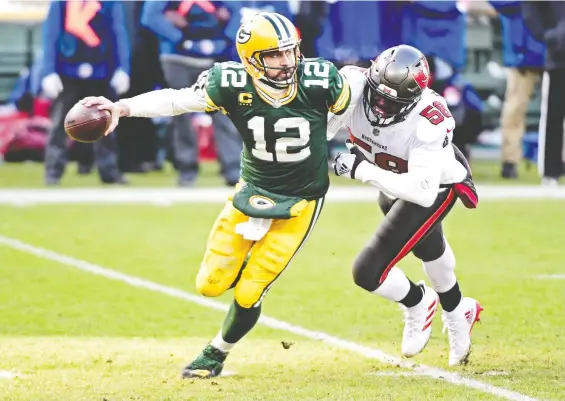  ?? BENNY SIEU/USA TODAY SPORTS ?? Packers quarterbac­k Aaron Rodgers, left, was down in the dumps following the loss to Jason Pierre-Paul and the Buccaneers in the NFC Championsh­ip Sunday.