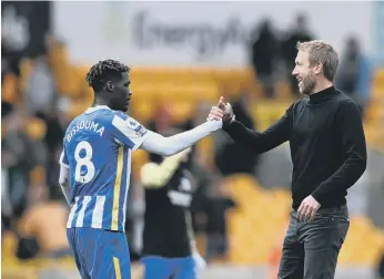  ?? ?? Yves Bissouma celebrates with Graham Potter after the Wolves game