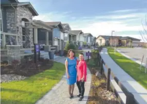  ??  ?? Toll Brothers’ Tanya Miller, left, and Leanne Mcguire show off the models at Inspiratio­n. Above right, the 20 Mile House community center and pool.