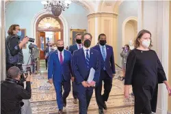  ?? J. SCOTT APPLEWHITE/ASSOCIATED PRESS ?? Democratic House impeachmen­t managers, from left, Rep. David Cicilline, D-R.I., Rep. Eric Swalwell, D-Calif., Rep. Jamie Raskin, D-Md., and Rep. Joe Neguse, D-Colo., leave the Senate chamber, escorted by acting sergeant-atarms Jennifer Hemingway, after the impeachmen­t trial of former President Donald Trump ended at the Capitol in Washington on Saturday.