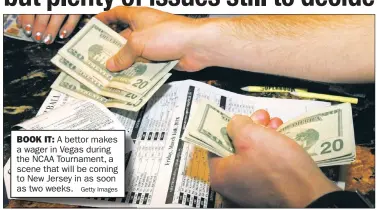  ?? Getty Images ?? BOOK IT:
A bettor makes a wager in Vegas during the NCAA Tournament, a scene that will be coming to New Jersey in as soon as two weeks.